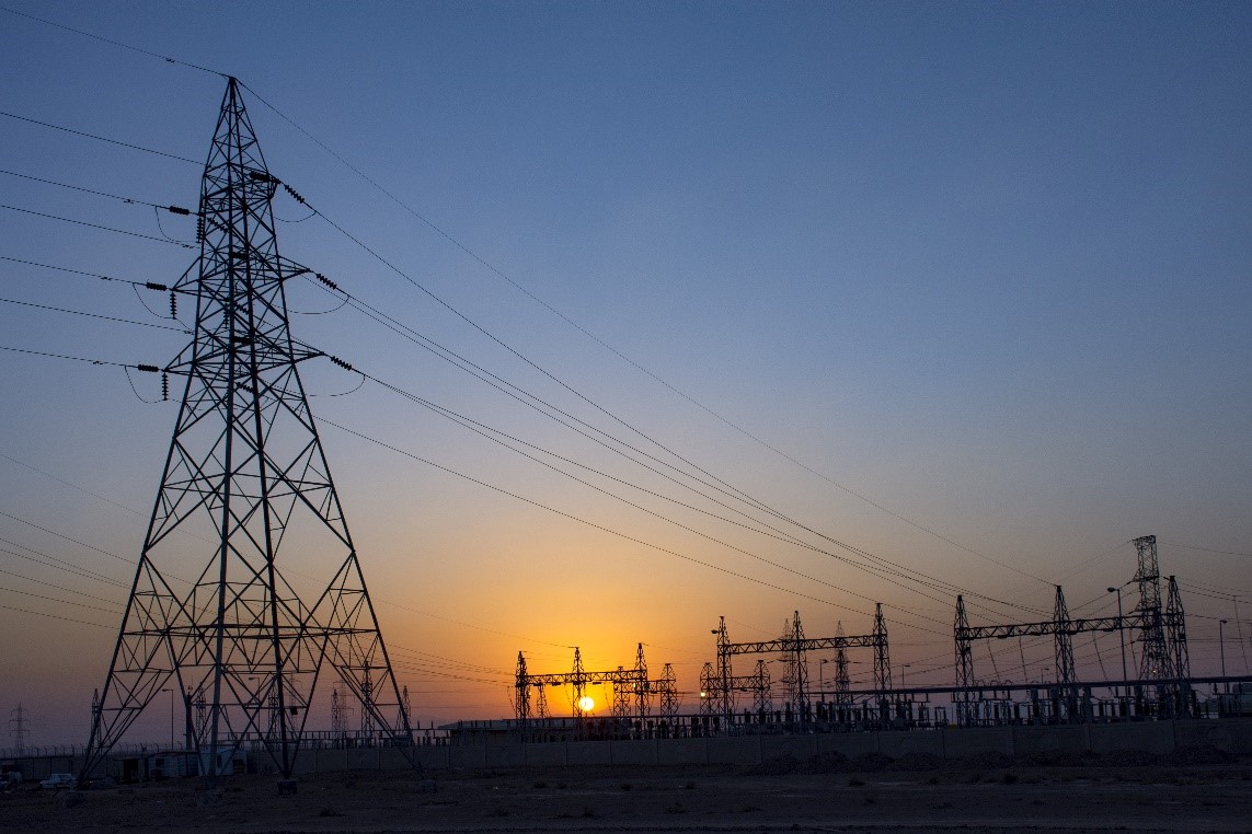 Powerst-built transmission line and substation yard at dusk